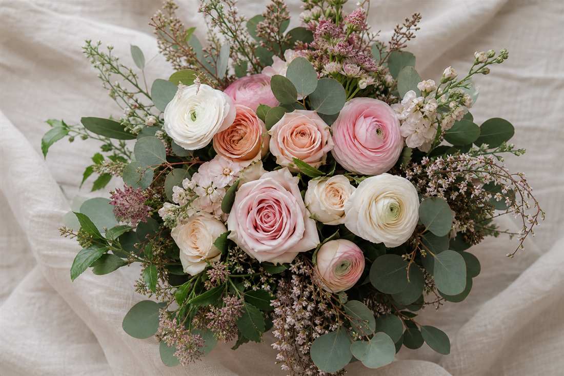 Hand-tied bouquet with peach roses and eucalyptus