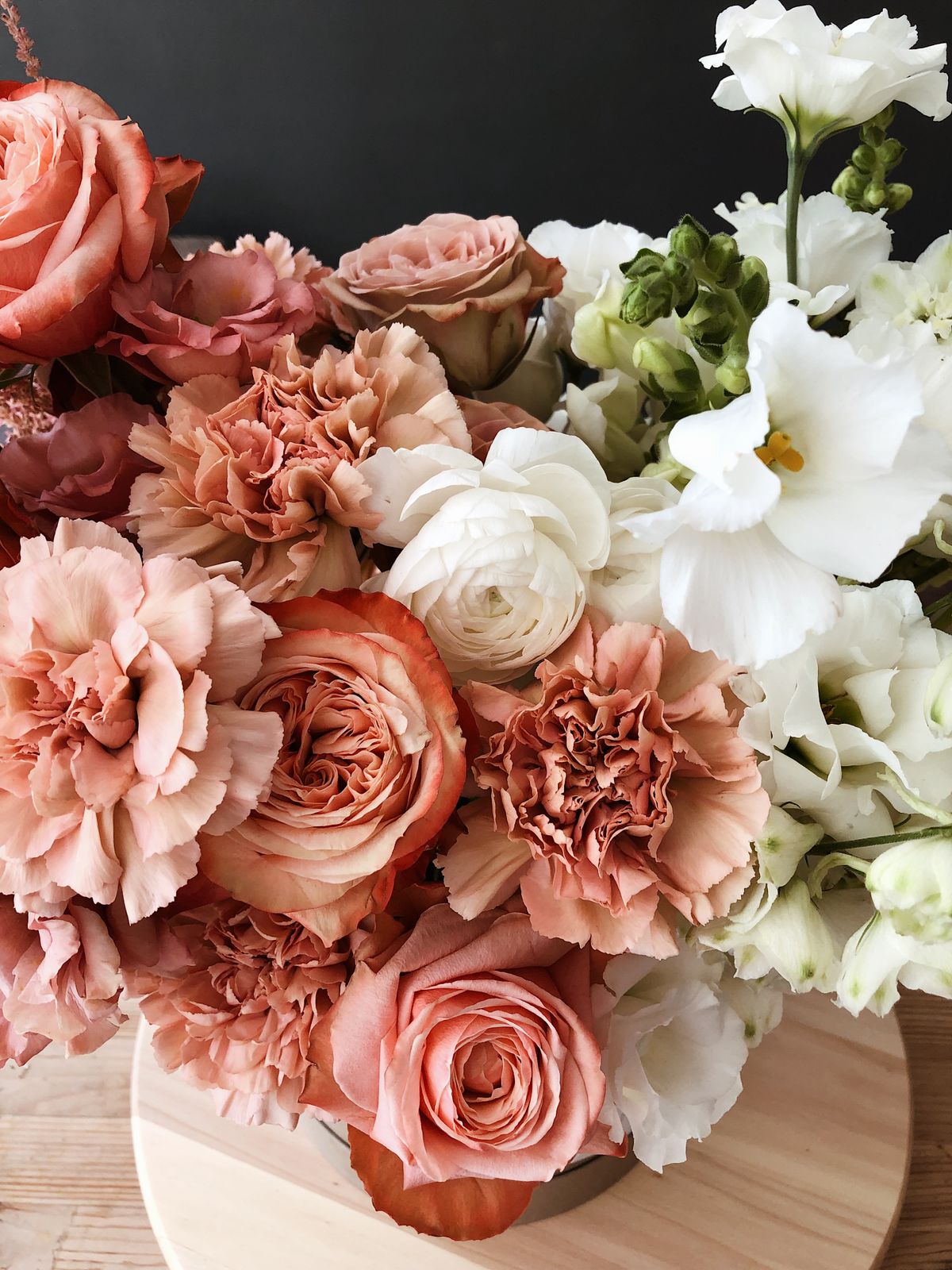 Warm terracotta and cream farewell floral arrangement